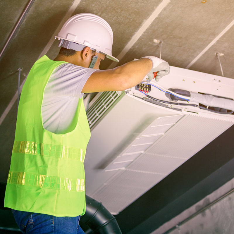 HVAC technician performing repairs