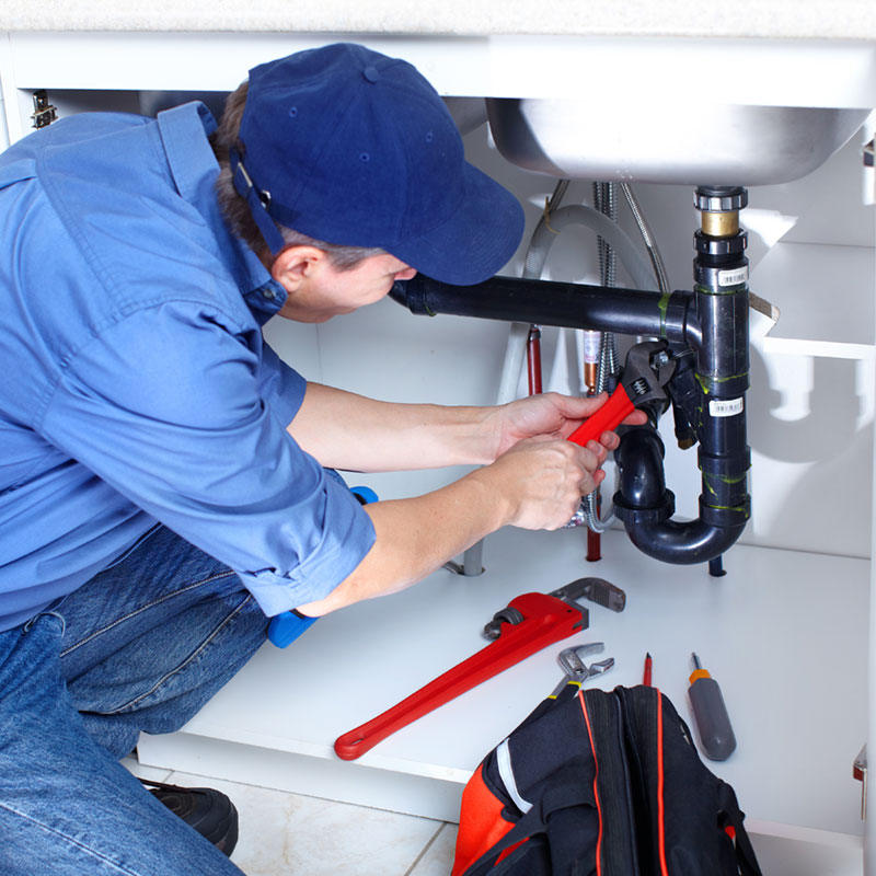 Plumber repairing a sink